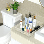 Clear acrylic tray organizing skincare and makeup products on a bathroom vanity