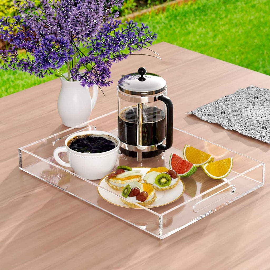 Clear acrylic tray serving coffee, tea, and breakfast items on an outdoor patio table