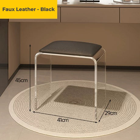 Clear acrylic vanity stool with black faux leather cushion, combining style and durability