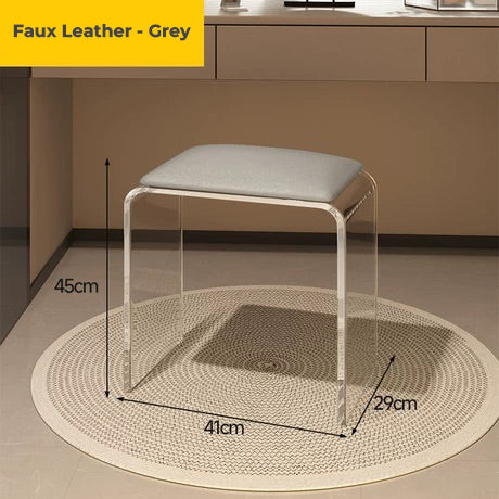 Clear acrylic vanity stool with grey faux leather cushion, designed for bathroom use