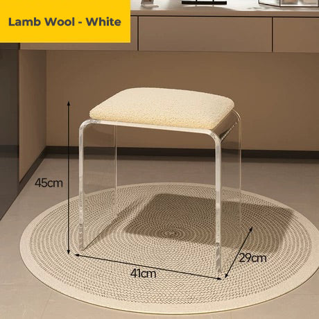 Clear acrylic vanity stool with white lamb wool cushion, showcasing its soft seating