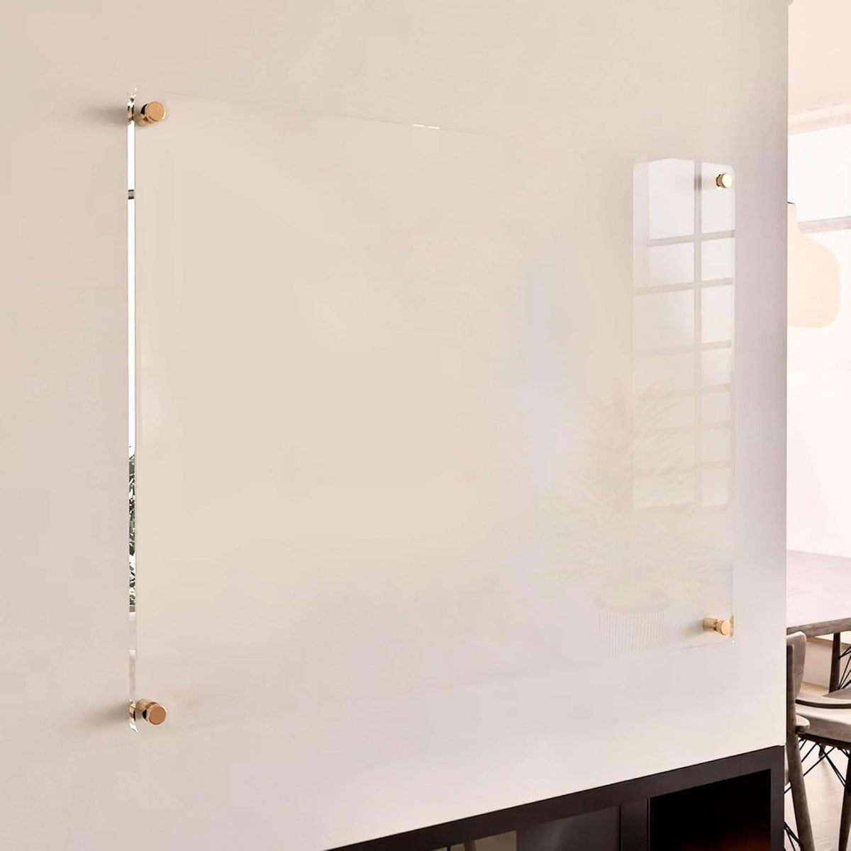 Sleek acrylic wall calendar mounted with gold hardware, blending into a modern interior