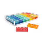 Rainbow acrylic domino game set in clear acrylic storage box with loose domino tiles on white background