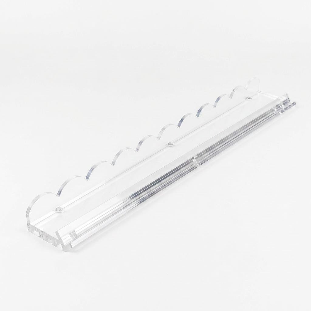 Clear scalloped acrylic mahjong rack with built-in magnetic tile pusher for American mahjong, white background