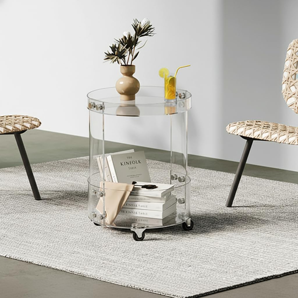 Modern clear acrylic side table styled in a living room, with a decorative vase and drink on top, and books stored on the lower shelf