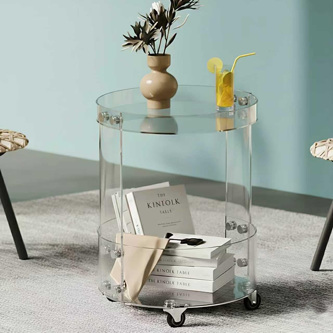 Round acrylic rolling table against a light blue background, featuring a minimalist, transparent design that blends storage and decor