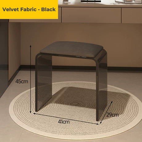 Smoke black acrylic vanity stool with black velvet fabric cushion, placed in a modern room
