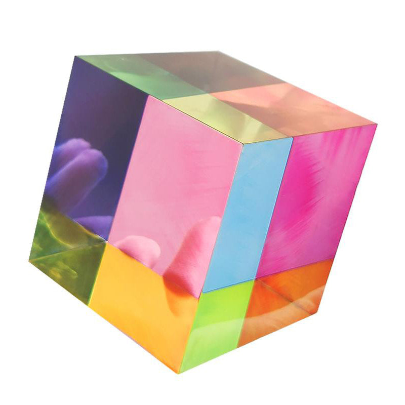 Transparent rainbow acrylic cube close-up, colorful panel acrylic decorative block with reflective surface