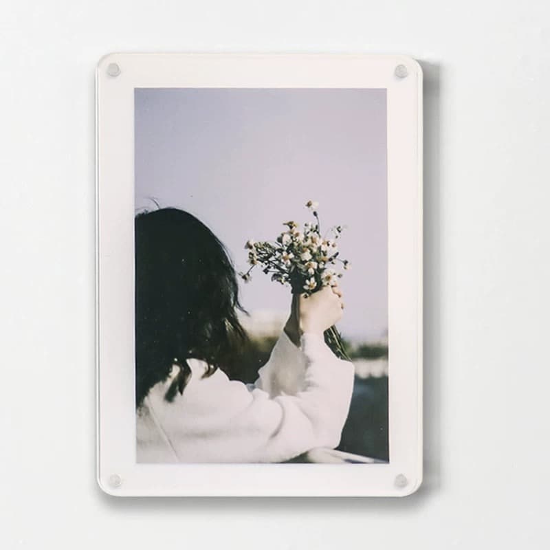 White base wall-mounted acrylic magnetic photo frame showing a photo of a person holding flowers