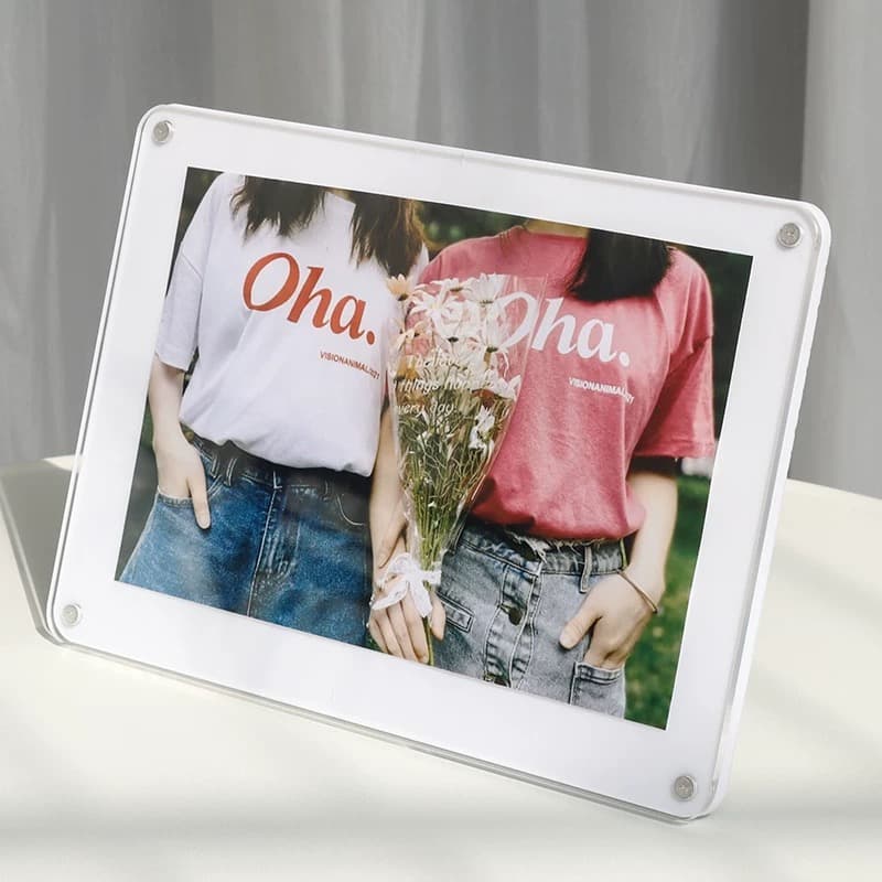 White base acrylic magnetic photo frame (tabletop) showing a photo of two friends with matching shirts and flowers